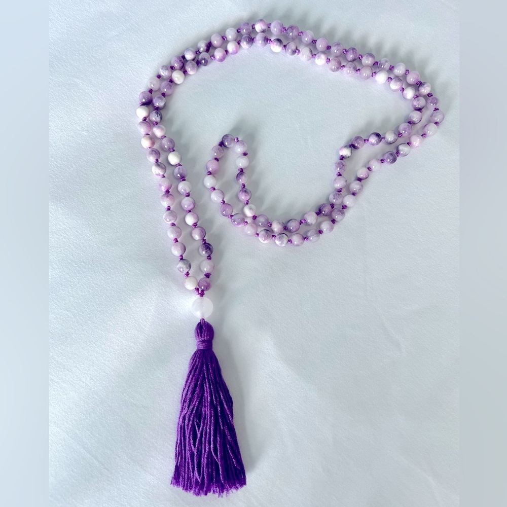Handmade Mala beads in purple and white.